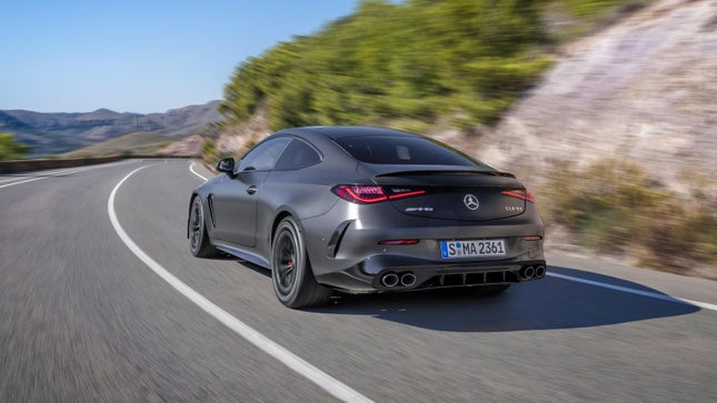 Rear 3/4 view of the black Mercedes-AMG CLE53 driving on the road